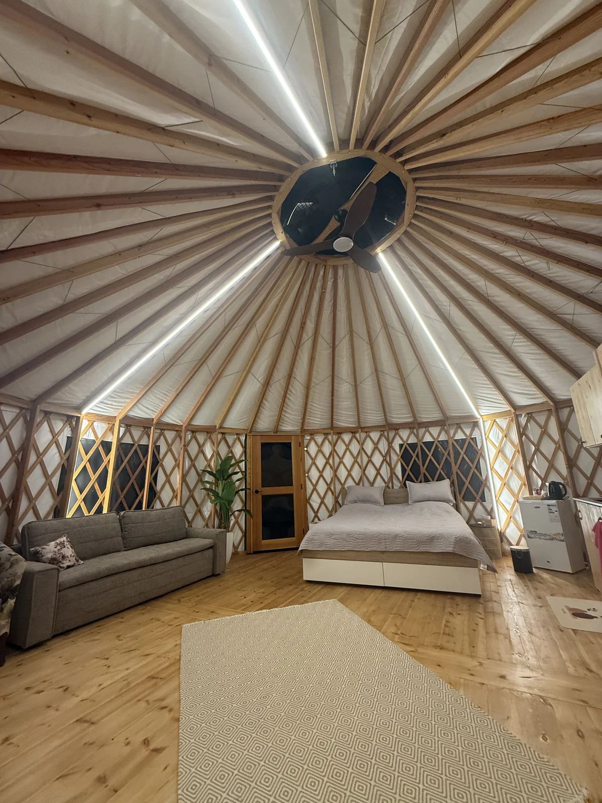 The central skylight and ceiling fan at the top of a Premium Yurt roof