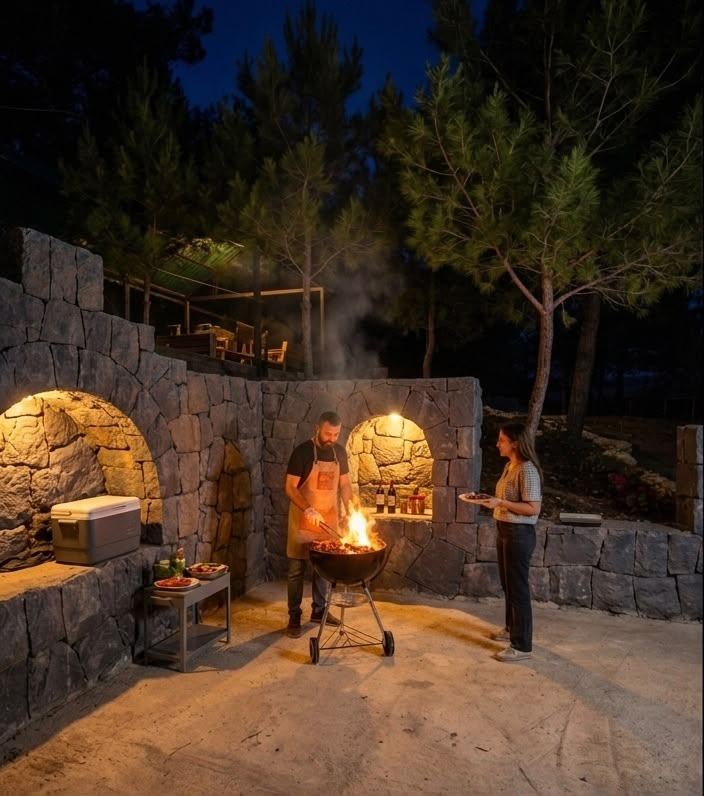 Guests grilling at the stone BBQ station at Horizon Pines in the evening