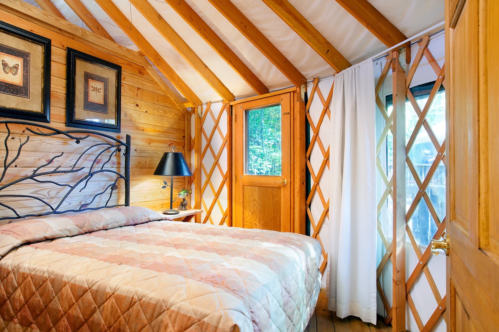 Cozy wooden yurt bedroom interior at Horizon Pines eco glamping in Lebanon