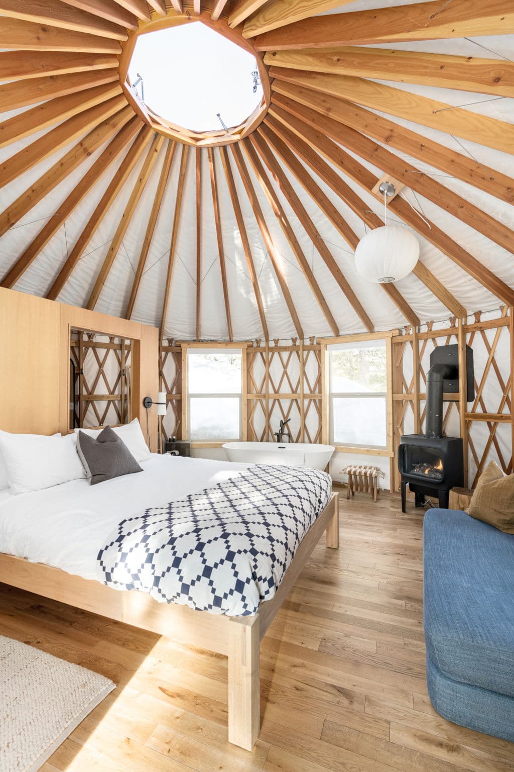 Bright yurt bedroom with skylight and freestanding bathtub at Horizon Pines Lebanon