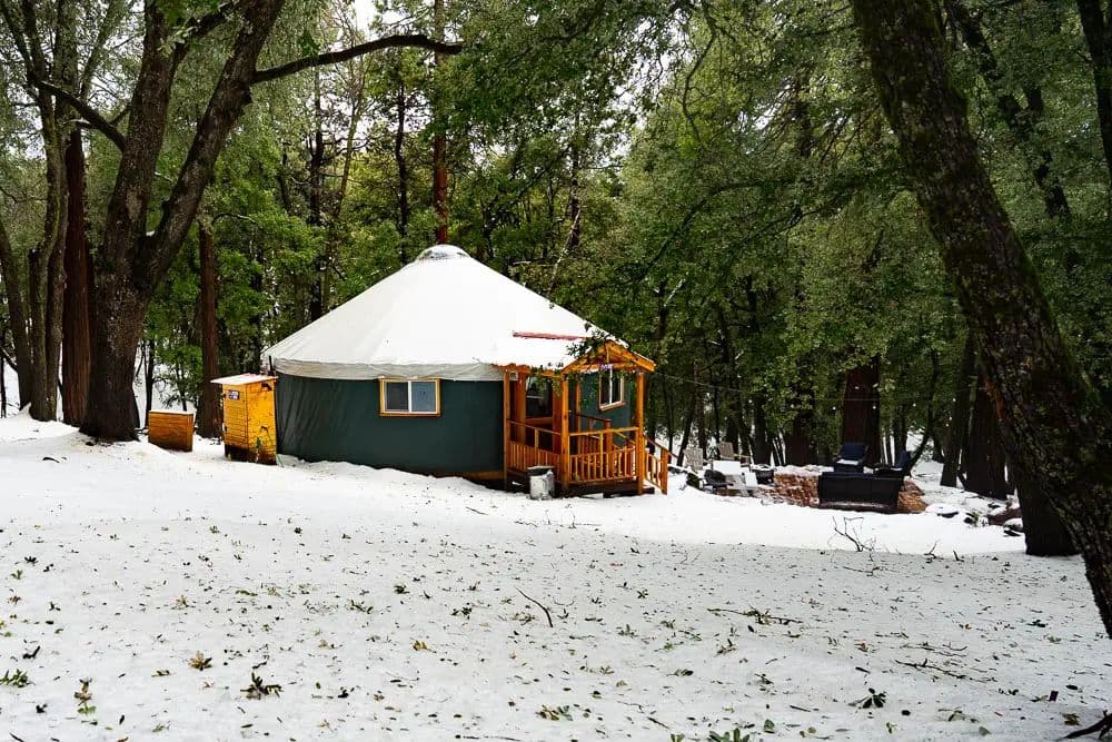 yurt covered in snow during winter, nestled among trees in the mountains of Kobayat Lebanon
