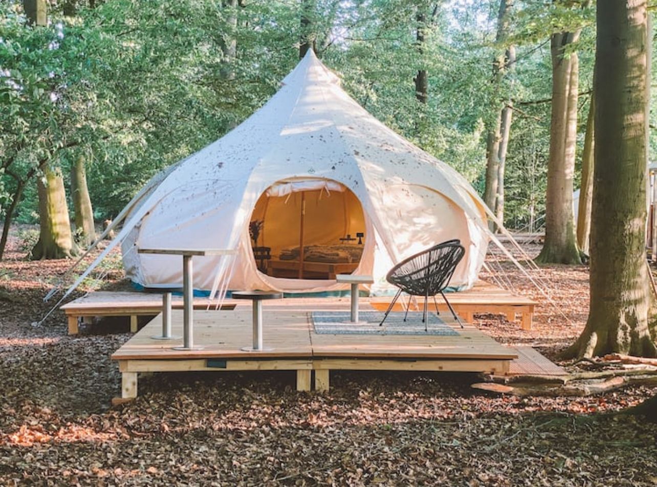 Inside view of Lotus Belle Tent showing cozy double bed and decor