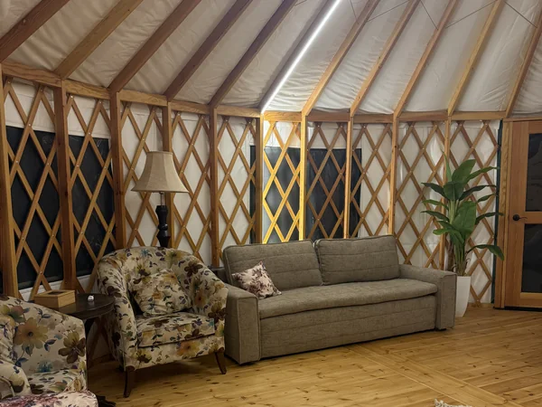 The sitting area: sofa bed and two armchairs on the timber floor