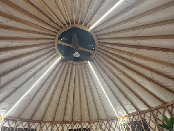 Inside the yurt, bedside detail and warm lighting